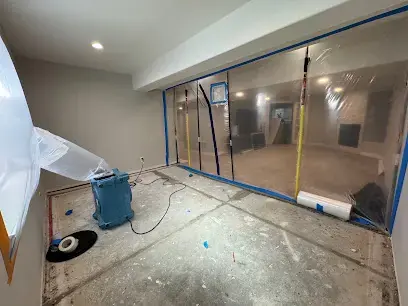 Containment wall and dehumidifier in a finished basement