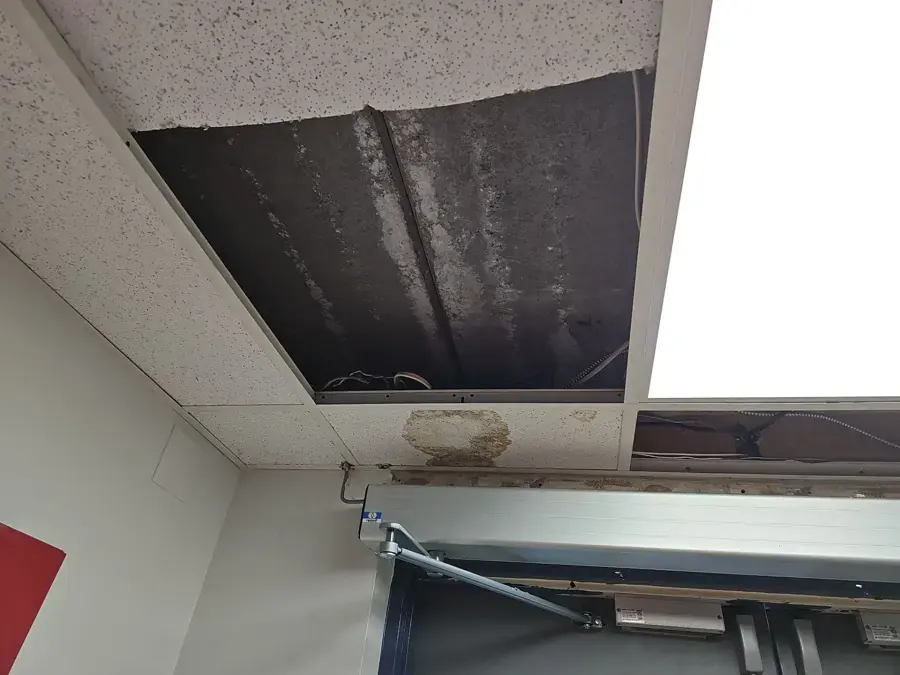 Drop ceiling tiles removed after a leak in a commercial space