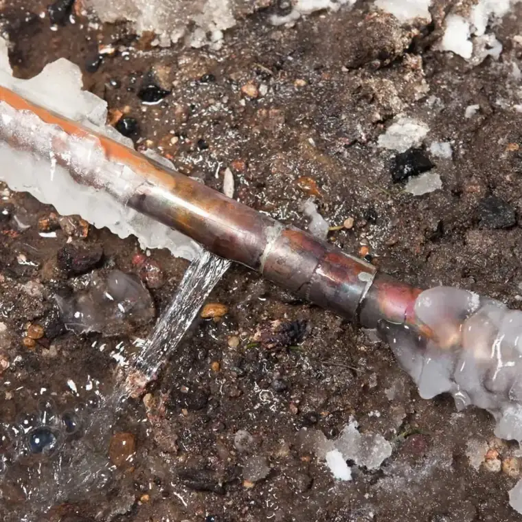 Split copper line leaking water through ice